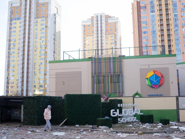 A woman passes by the area which was hit with a missile in Kyiv. Picture: Anastasia Vlasova/Getty Images