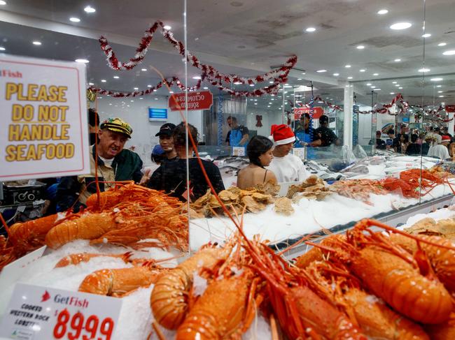 SYDNEY, AUSTRALIA - NewsWire Photos DECEMBER 24, 2024: People queue for seafood at the Sydney Fish Market in Pyrmont on Christmas Eve. Picture: NewsWire / Nikki Short