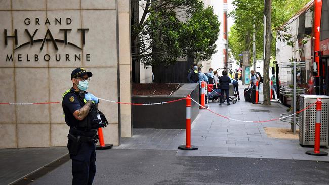 Standing guard outside the Grand Hyatt hotel as tennis players and officials arrive for a two-week quarantine period ahead of the Australian Open. Picture: AFP