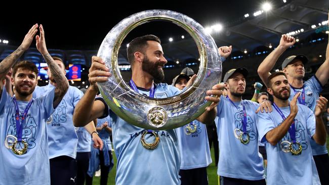 Captain Alex Brosque holds the A-League trophy as Sydney FC players celebrate winning last season’s grand final. Picture: Getty Images