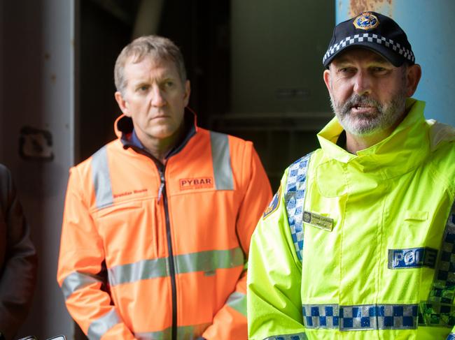 Pybar Mining Services CEO Brendan Rouse looks on as Inspector Shane le Fevre addresses the media about progress in the rescue attempt for a missing miner. Picture: GRANT WELLS