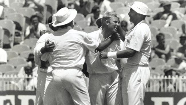 Shane Warne is congratulated by teammates after taking a wicket during the 1992 Boxing Day Test against West Indies.