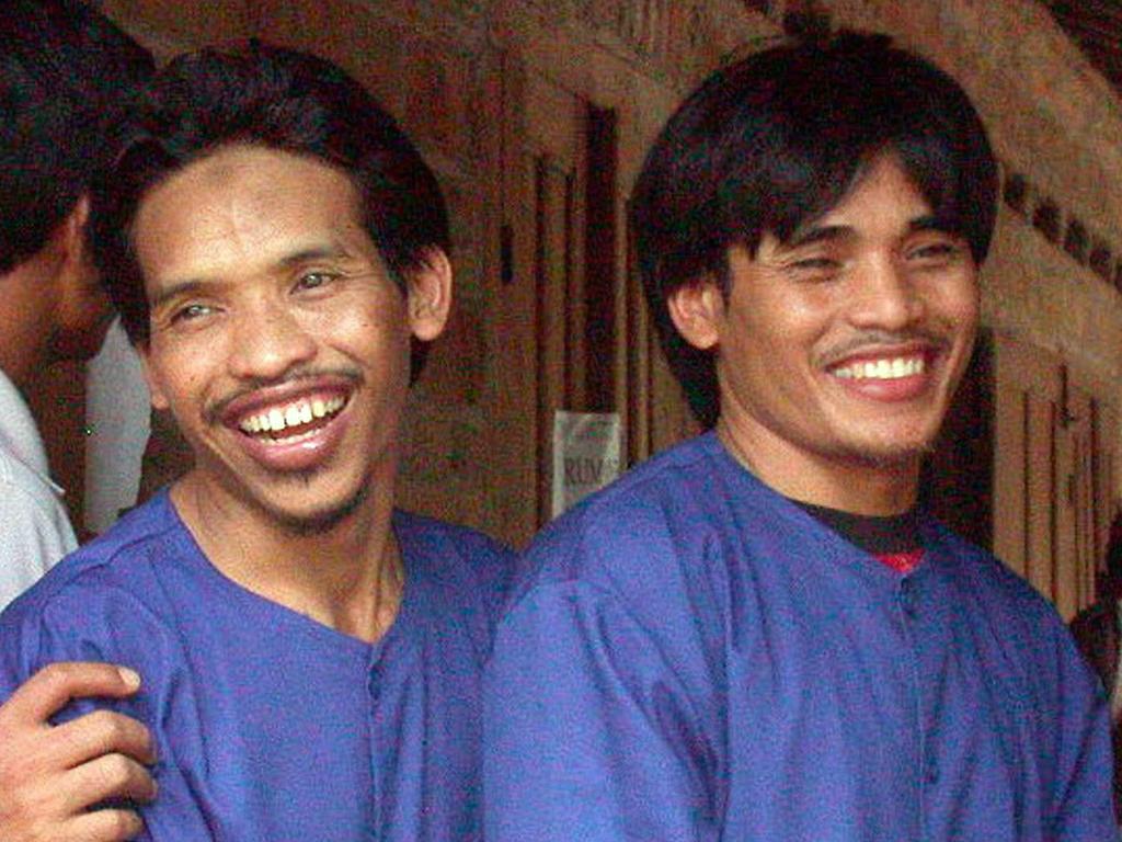 This file photo taken in 2002 shows two of the Bali bombers, Mukhlas (left) and Amrozi (right), smiling during a reconstruction meeting in Solo, Central Java.