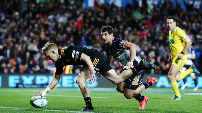 Damian McKenzie of the Chiefs scores a try against Tomas Cubelli of the Brumbies.