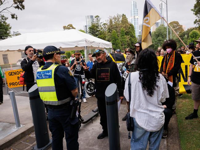 A small protest gathered outside Government house gates before the flag raising ceremony in Victoria. Picture: NewsWire / Nadir Kinani