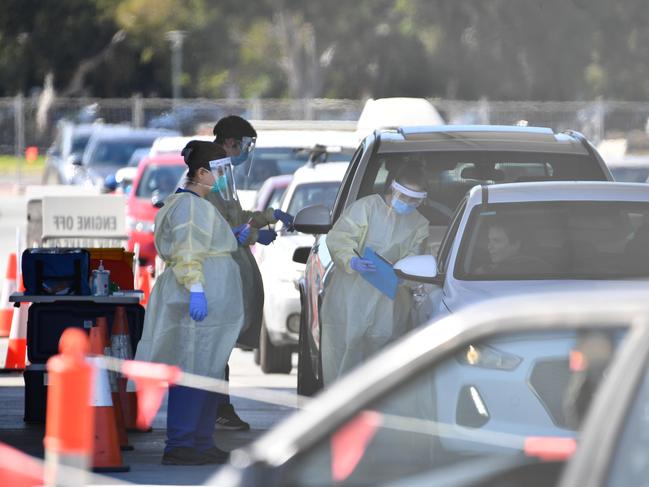 Health authorities carry out coronavirus tests on people in cars at the Victoria Park COVID-19 testing centre in Adelaide’s northern suburbs yesterday. Picture: Getty Images