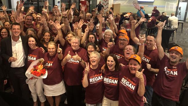 Victorious independent Michael Regan (left) celebrates with volunteers and supporters on Saturday night at the Manly Warringah Football Club. Picture :Jim O'Rourke