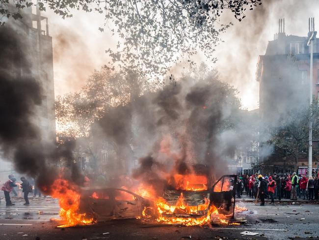 Cars torched ... crowd estimates varied from 100,000 to 130,000. Picture: AP Photo/Geert Vanden Wijngaert