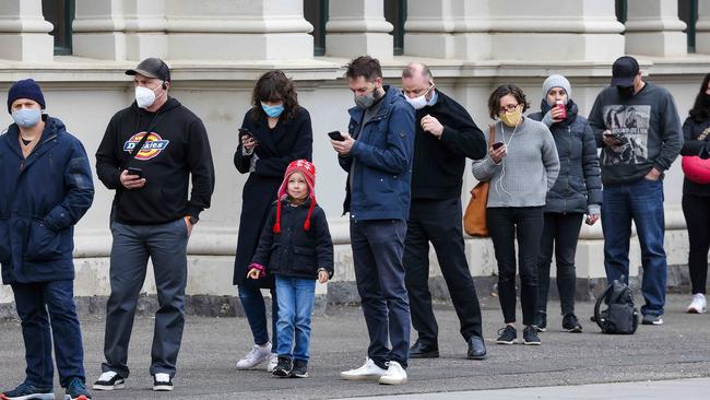 There have been long lines of people waiting to get their vaccination at the Royal Exhibition Building. Picture: Ian Currie