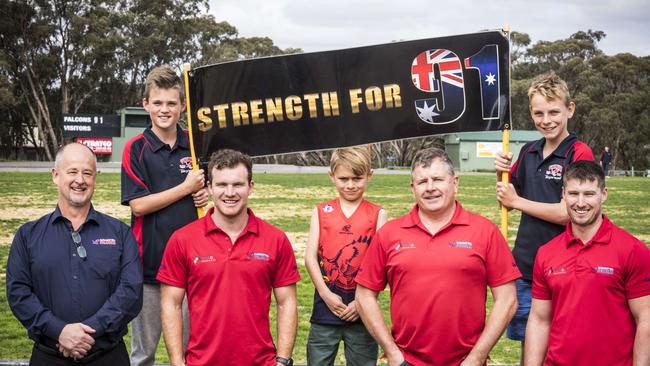 Flagstaff Hill Football Club, has thrown its support behind former player Sam Willoughby. Pictured are president Brett Charlesworth, Ben Haslan, 7, captain Michael Shearer, Blake Aldrige, 12, coach Rod Mitchell, Sam’s brother Matt Willoughby and Kobe Vanzetta, 13. Picture: Nick Clayton.