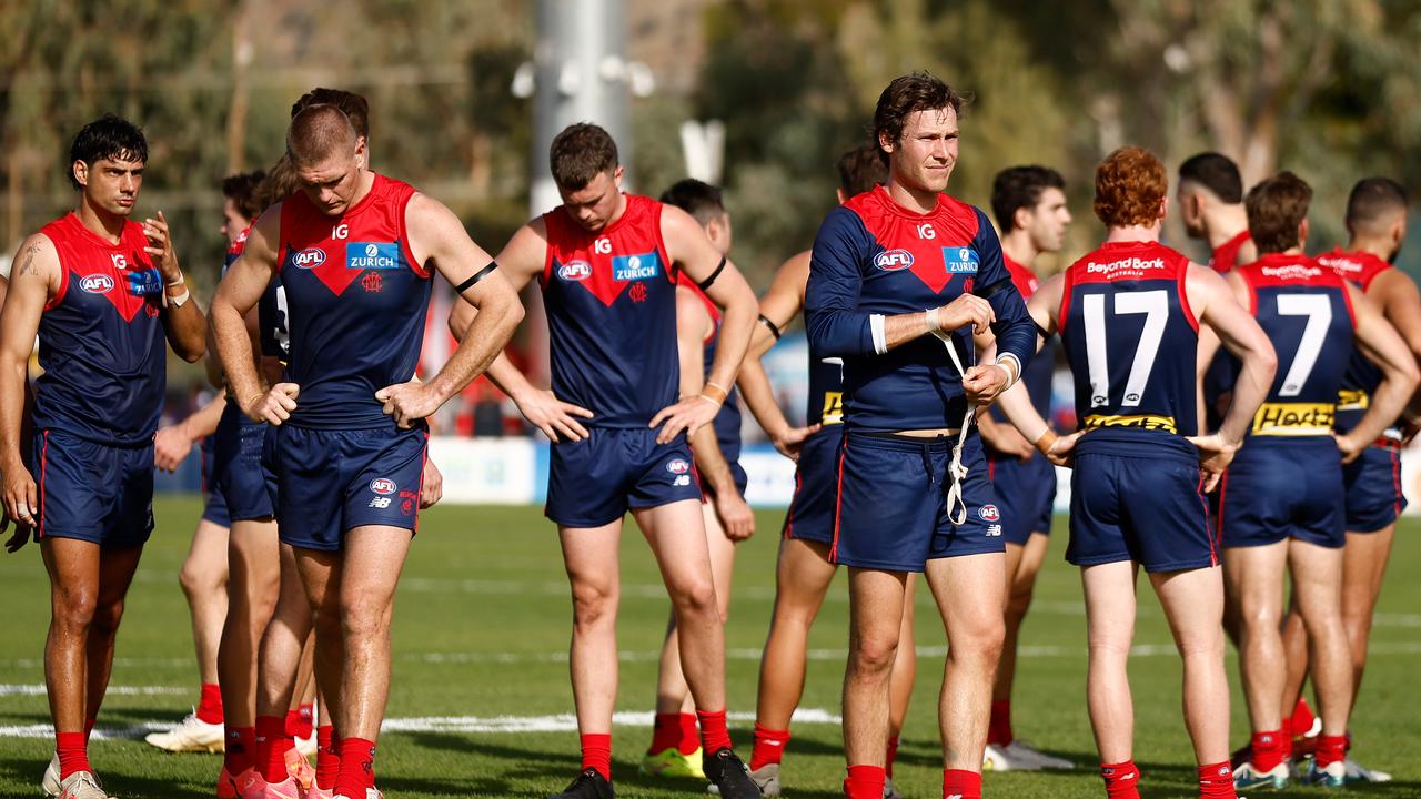 ALICE SPRINGS, AUSTRALIA - JUNE 02: The Demons look dejected after a loss during the 2024 AFL Round 12 match between the Melbourne Demons and the Fremantle Dockers at TIO Traeger Park on June 02, 2024 in Alice Springs, Australia. (Photo by Michael Willson/AFL Photos)