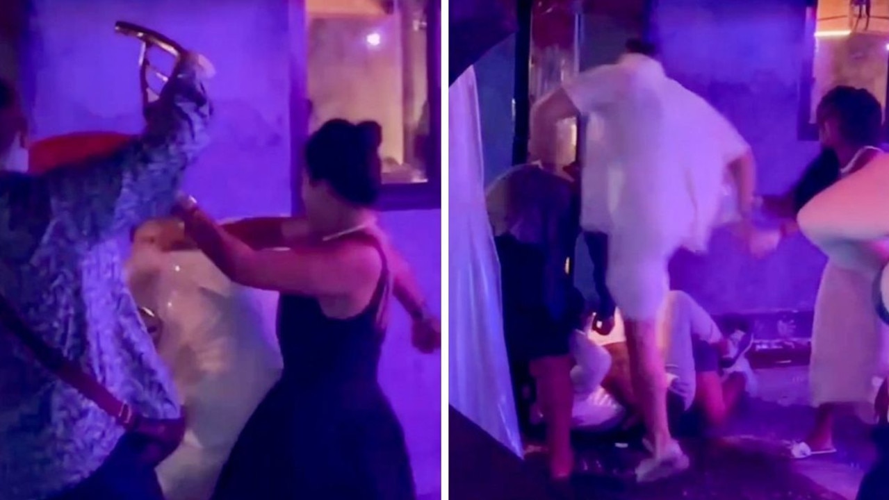 One man was seen hitting him with a chair and another pinned him down, while another women attempted to pull Colhoun away.