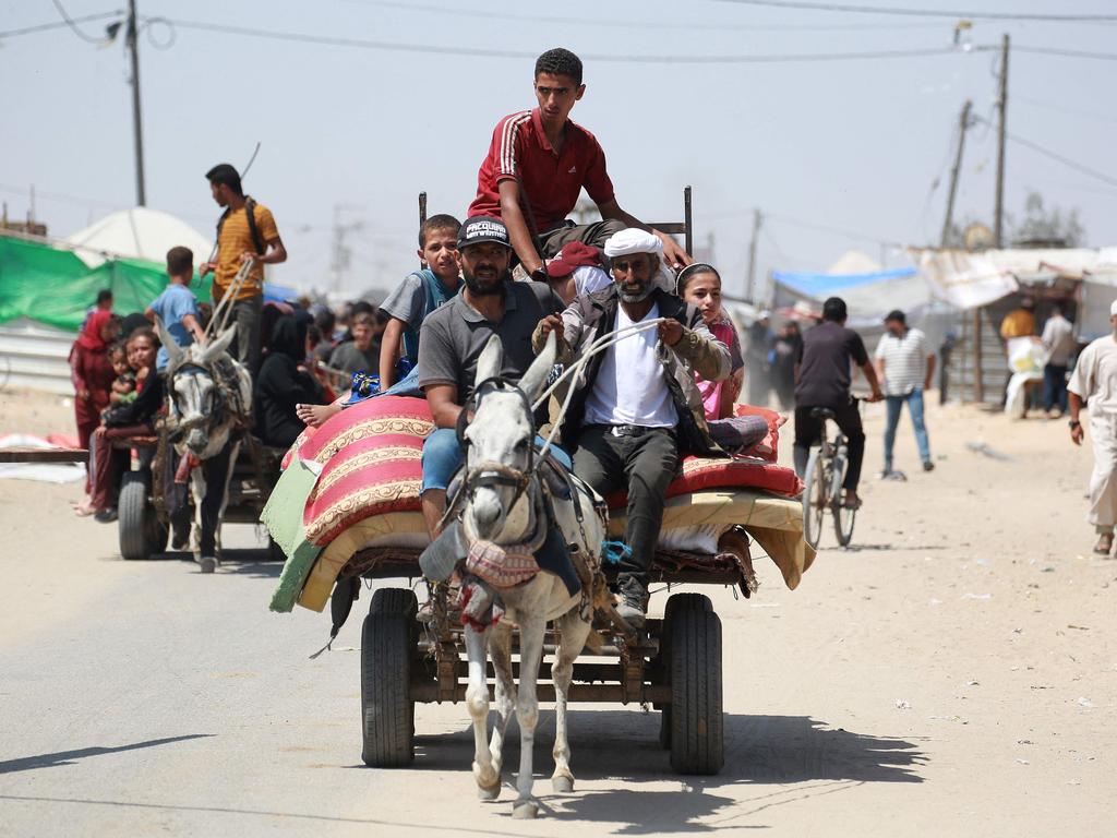 Palestinians ride in an animal-pulled cart in an area housing displaced people in Rafah. Picture: AFP