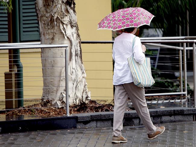 Wet weather hits Ipswich: a woman holding an umbrellaPhoto: Sarah Keayes / Queensland Times