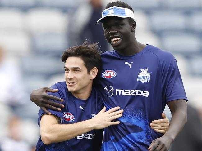 GEELONG, AUSTRALIA - APRIL 14: Zac Fisher share an embrace with Bigoa Nyuon of the Kangaroos before the round five AFL match between Geelong Cats and North Melbourne Kangaroos at GMHBA Stadium, on April 14, 2024, in Geelong, Australia. (Photo by Darrian Traynor/Getty Images)