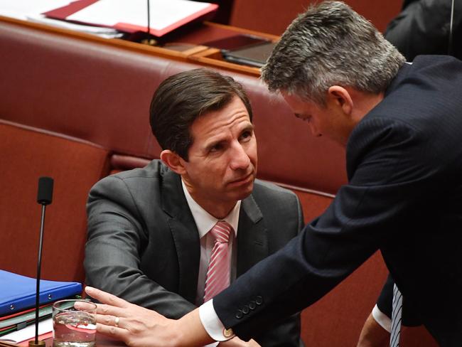 Minister for Education Simon Birmingham and Minister for Finance Senator Mathias Cormann in the Senate chamber at Parliament House in Canberra, Monday, March 26, 2018. (AAP Image/Mick Tsikas) NO ARCHIVING