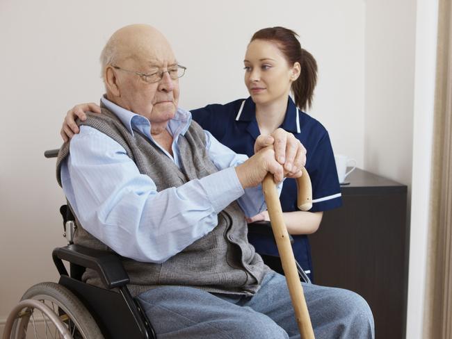 28/01/2013 NEWS: young nurse hugging senior man in wheelchair. Unhappy elderly man. Aged care. Generic, Thinkstock Pic. Supplied