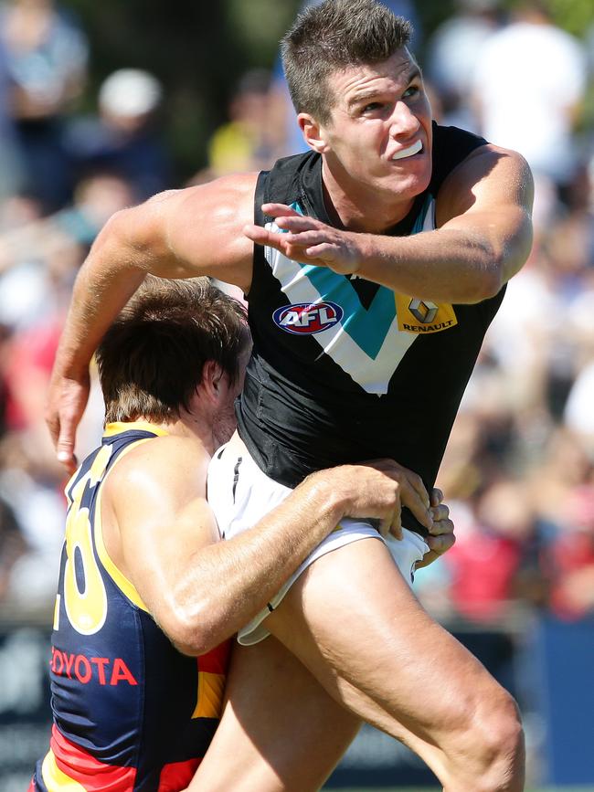 Back in the day: Crow Richard Douglas tackles Power’s Paul Stewart when they faced off in a NAB Challenge Showdown at Richmond Oval in 2014. Picture: SARAH REED.