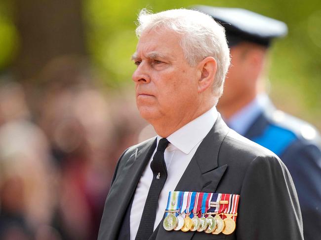 Britain's Prince Andrew, Duke of York follows the coffin of Queen Elizabeth II, adorned with a Royal Standard and the Imperial State Crown and pulled by a Gun Carriage of The King's Troop Royal Horse Artillery, during a procession from Buckingham Palace to the Palace of Westminster, in London on September 14, 2022. - Queen Elizabeth II will lie in state in Westminster Hall inside the Palace of Westminster, from Wednesday until a few hours before her funeral on Monday, with huge queues expected to file past her coffin to pay their respects. (Photo by Martin Meissner / POOL / AFP)