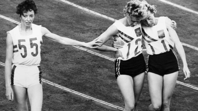 Ann Packer (left) silver medallist acknowledges defeat at the hands of Betty Cuthbert (centre), winner of the 400 metres at the Tokyo Olympic Games. Bronze medallist Judith Amoore is on the right. (Photo by Central Press/Getty Images)