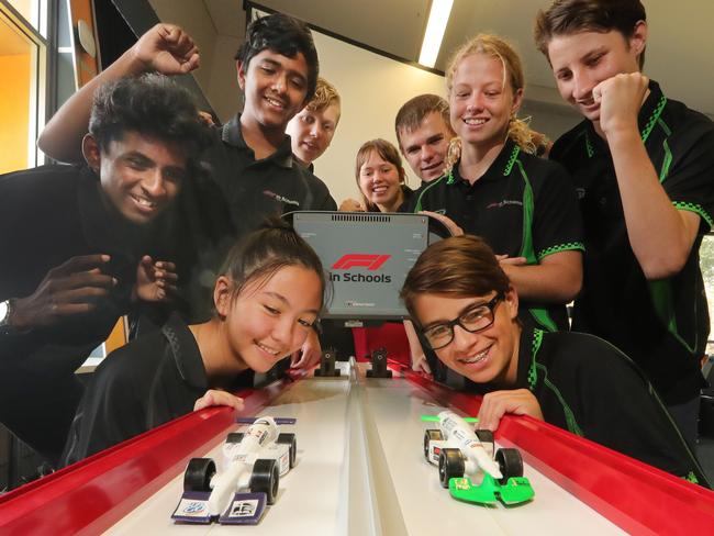 Students from Grade 9,10 and 11, including Ali Savage, 15, and Taine Stevens, 15, cheer their cars down the track. Picture Glenn Hampson