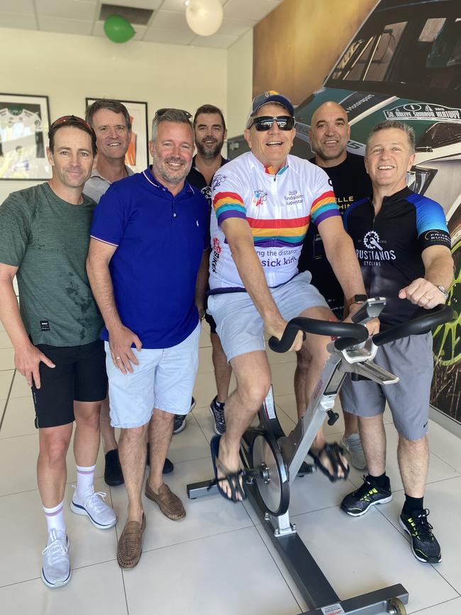 Rugby legend Gorden Tallis with Brett Frizelle at Frizelle Sunshine Automotive in Southport riding a spin bike to raise money for the Children's Starlight Foundation Tour De Kids. Photo: Supplied