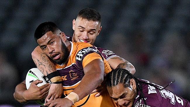 Payne Haas of the Broncos is tackled by Danny Levi (left) Martin Taupau and Corey Waddell of the Sea Eagles during the Round 5 NRL match between the Manly Sea Eagles and the Brisbane Broncos at Central Coast Stadium in Gosford, Thursday, June 11, 2020. (AAP Image/Dan Himbrechts) NO ARCHIVING, EDITORIAL USE ONLY