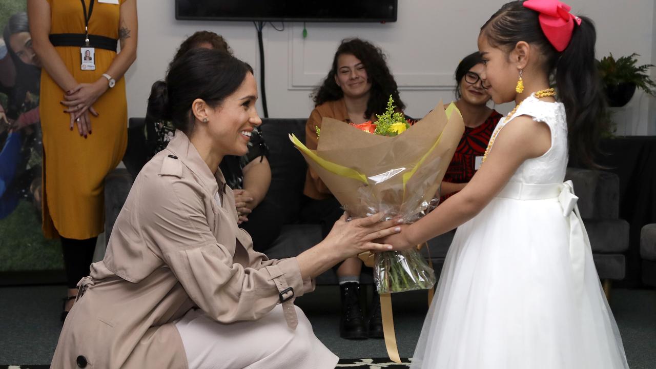 Meghan received a bouquet of flowers from a young girl. Credit: AP Photo/Kirsty Wigglesworth, Pool