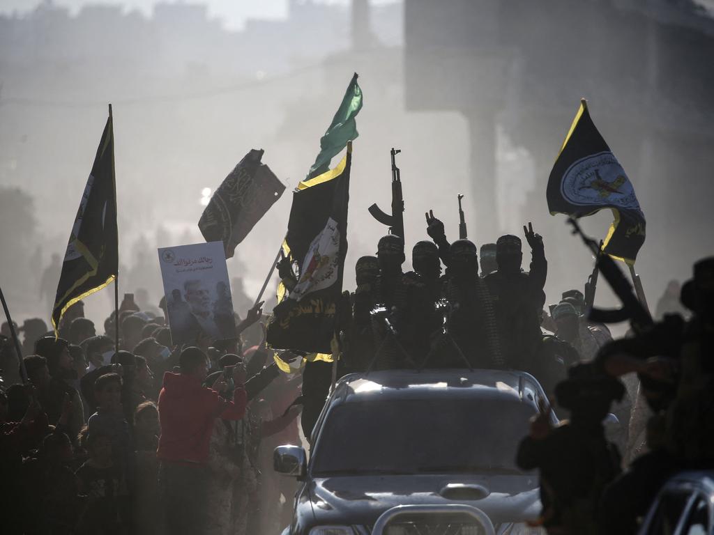 Palestinian Islamic Jihad fighters arrive near the family home of slain Hamas leader Yahya Sinwar, where the Hamas militant group prepared to hand over Israeli and Thai hostages to a Red Cross team in Gaza. Picture: AFP