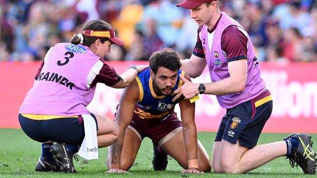 Callum Ah Chee in the hands of trainers after copping a big bump from Patrick Cripps. Picture: Getty Images