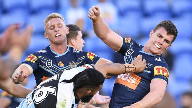 GOLD COAST, AUSTRALIA - JULY 04: Siosifa Talakai of the Sharks fends off Beau Femor of the Titans during the round eight NRL match between the Gold Coast Titans and the Cronulla Sharks at Cbus Super Stadium on July 04, 2020 in Gold Coast, Australia. (Photo by Ian Hitchcock/Getty Images)