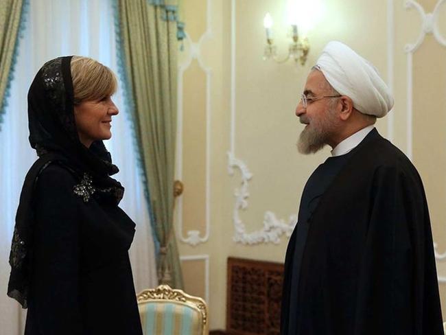 Bishop, pictured with Iran's President Hassan Rouhani, was required to wear a hijab to attend meetings so opted for a glamorous Armani scarf.