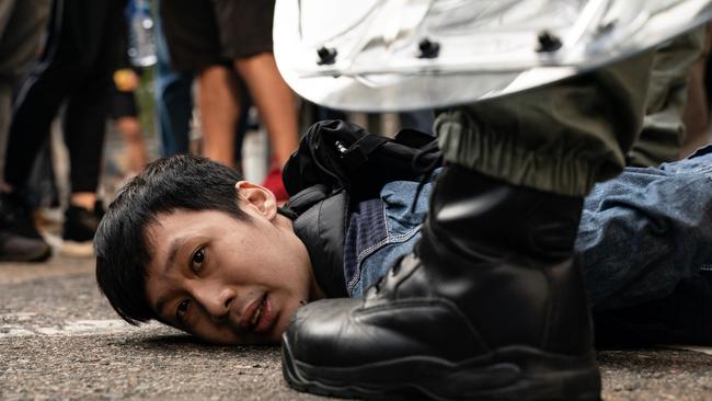 A pro-democracy protester is detained by riot police in Hong Kong. Picture: Getty