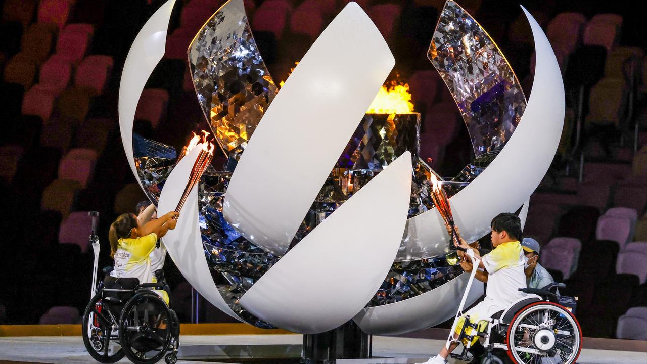 Japanese athletes Karin Morisaki, Yui Kamiji and Shunsuke Uchida light the flame at the opening ceremony of the Tokyo Paralympic Games. Picture: Getty Images