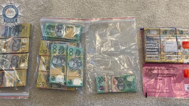 Some of the $160,000 seized from a safe at the home of a Helensvale man (pictured). Photo - AFP