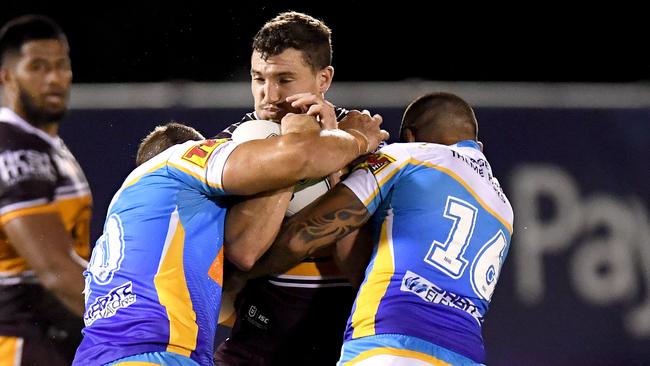 Corey Oates is wrapped up by the Titans defence. Picture: Getty Images