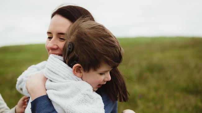 Henry Selby, 9, with mother Lisa. Henry’s cochlear implant was not programmed correctly.