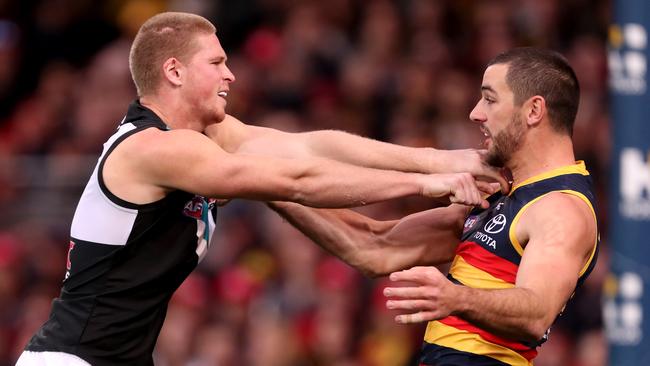 Tom Clurey of the Power clashes with Taylor Walker of the Crows during the Showdwon. Picture: Getty Images