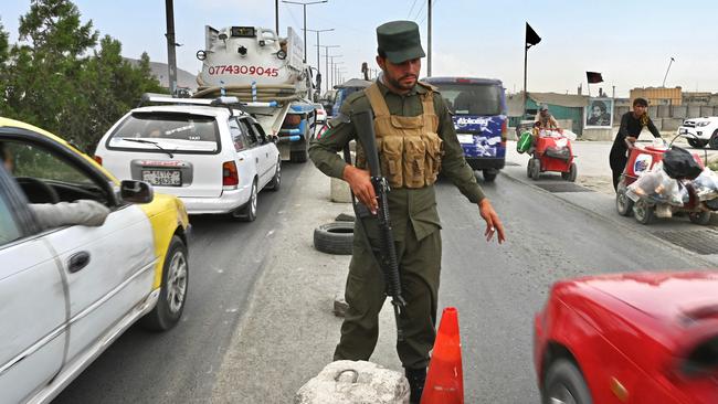 An Afghan policeman stands guard at a checkpoint along the road in Kabul. Picture: AFP