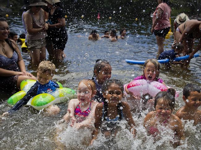 People cool off at lake Parramatta. Dante Jants, 5, and Tina Jants, 4 in star floaties and Maleah Carr (braids). Picture: Jenny Evans