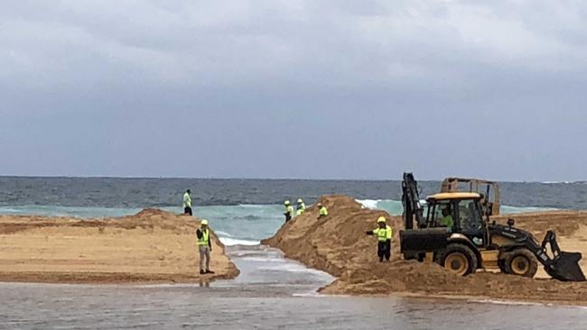 Council contractors opened Narrabeen Lagoon to the ocean at North Narrabeen Beach to reduce water levels ahead of the rain event. File picture: Jim O'Rourke