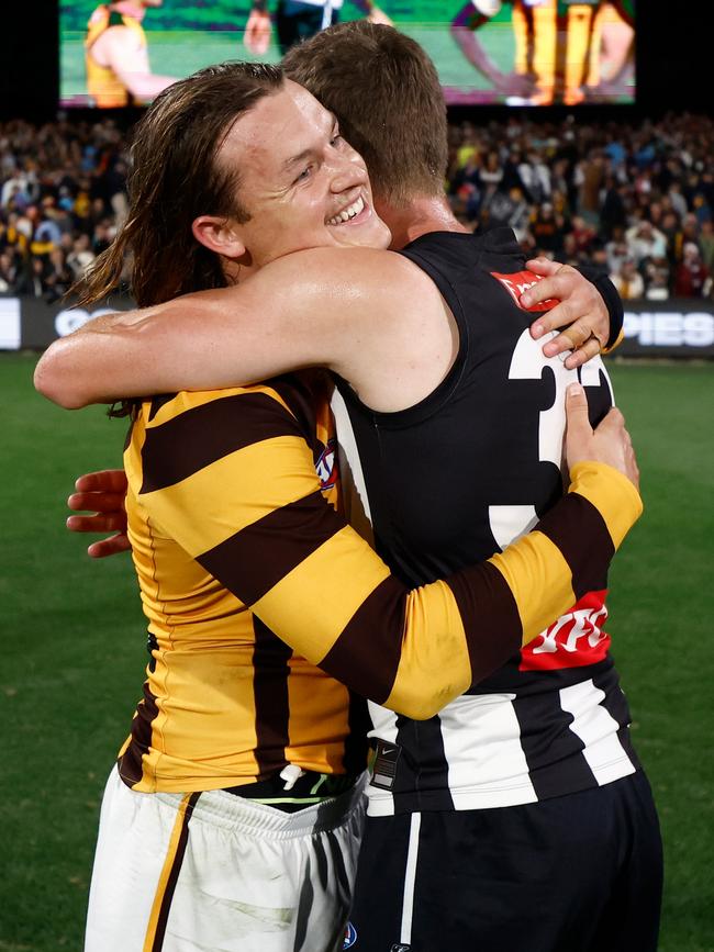 Ginnivan embraces Will Hoskin-Elliott after his first game against the Magpies.