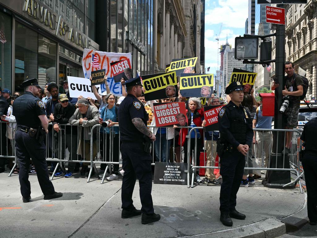 Protesters hold placards outside Trump Tower in New York City. Picture: Angela Weiss (AFP)