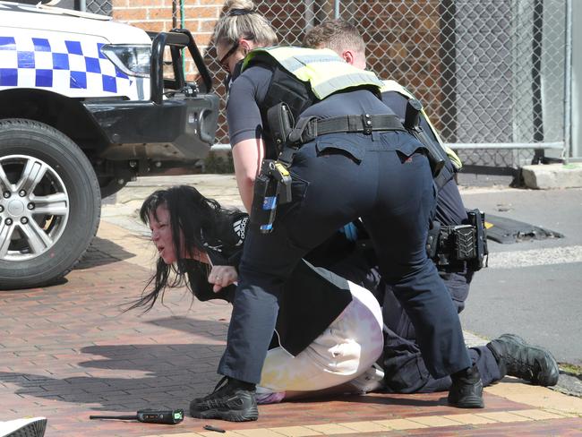 Preston’s partner is restrained by police after arriving at the shooting scene. Picture: David Crosling