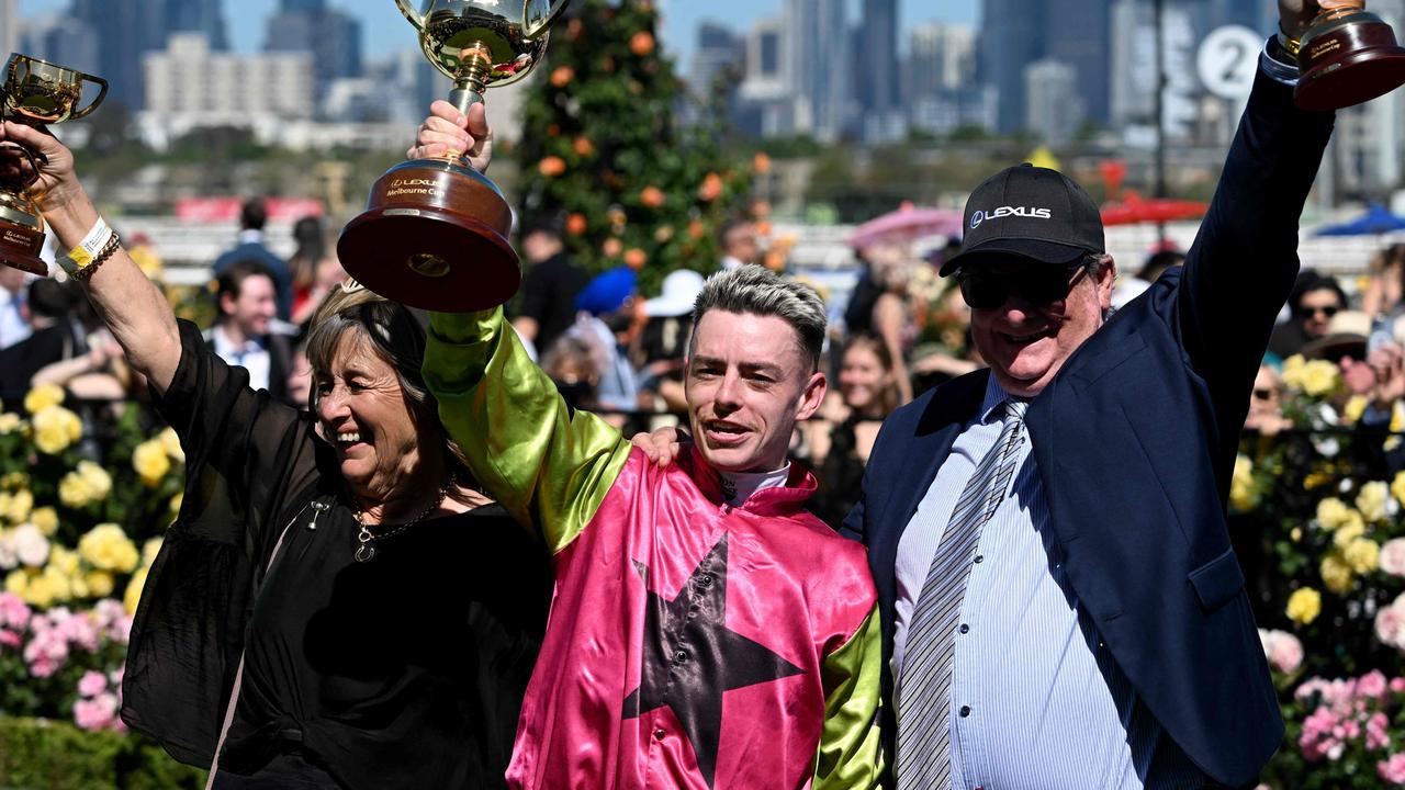 Irish jockey Robbie Dolan (C) celebrates with trainers Sheila Laxon (L) John Symonds (R) after riding Knight's Choice Knight's Choice to victory in the Aus$8 million (USD 5.25 million) Melbourne Cup horse race at Flemington racecourse in Melbourne on November 5, 2024. (Photo by William WEST / AFP) /