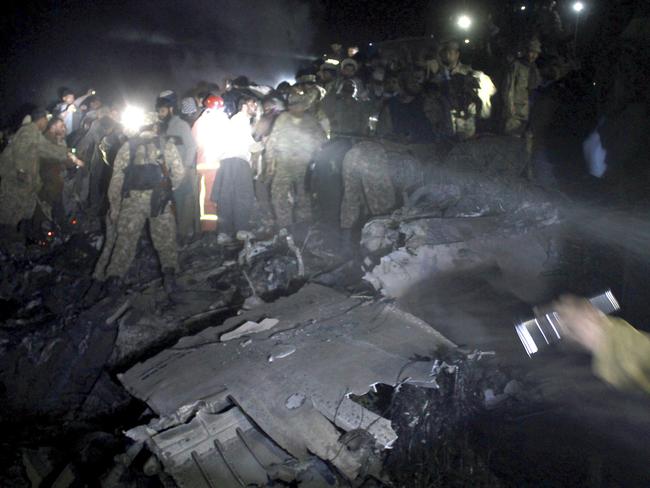 Pakistan army troops and rescue workers search for bodies at the site of a plane crash, in a village near the town of Havelian, about 75 kilometres (45 miles) northwest of the capital, Islamabad, Pakistan, Wednesday, Dec. 7, 2016. Picture: AP Photo/Aqeel Ahmed