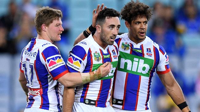 Brock Lamb (centre) with Knights teammates Luke Yates (left) and Dane Gagai. Photo: AAP