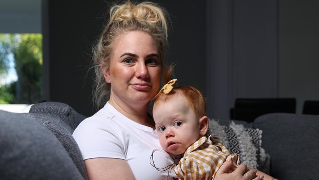 Meagan Hammond at home with daughter Lukah 1, who is battling the National Disability Insurance Scheme who have cut funding to her only treatment. Picture Lachie Millard