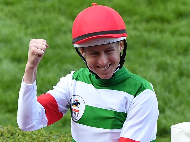 Jockey Damian Lane (centre) reacts after riding Lys Gracieux to Victory in race 9, the Ladbrokes Cox Plate during Cox Plate Day at Moonee Valley Racecourse, Melbourne, Saturday, October 26, 2019. (AAP Image/James Ross) NO ARCHIVING