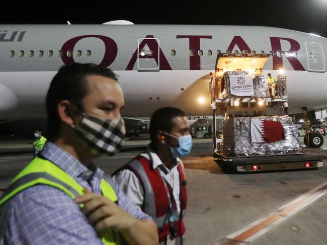 (FILES) In this file photo taken on April 28, 2020, supplies to tackle the coronavirus COVID-19 pandemic donated by the Qatar Fund for Development are loaded onto a Qatar Airways flight to Kigali in Rwanda at Doha's Hamad International Airport. - Revelations that passengers flying through Doha were forced to endure vaginal inspections have upended Qatar's efforts to boost its reputation before the Gulf state hosts World Cup 2022, experts say. Officers marched women off a Sydney-bound Qatar Airways flight earlier this month and forced them to undergo intimate examinations after a newborn baby was found abandoned in an airport bathroom. (Photo by KARIM JAAFAR / AFP)